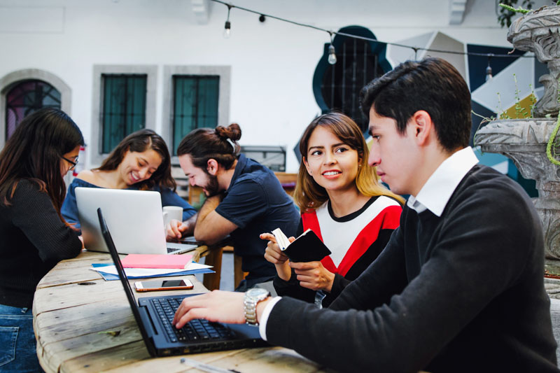 Group Of Young Latin College Students Developing A Project